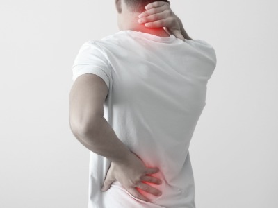 image of someone holding red area of neck and lower back